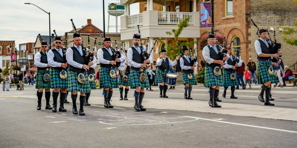 A bagpipe band performing on a street