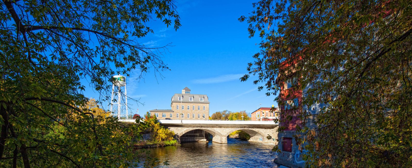 vehicle bridge over water, a water tower and buildings