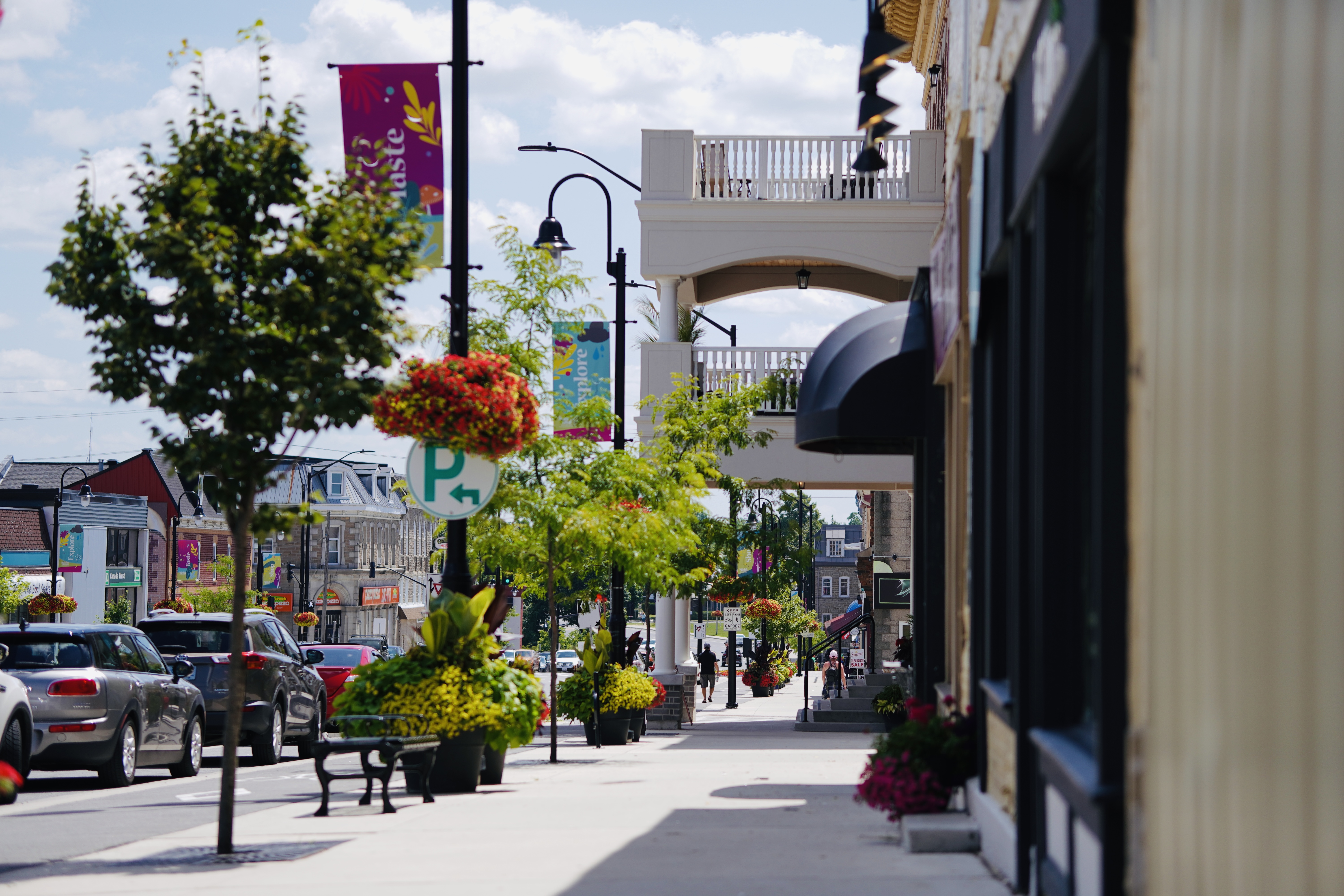 downtown sidewalk with flower baskets hanging