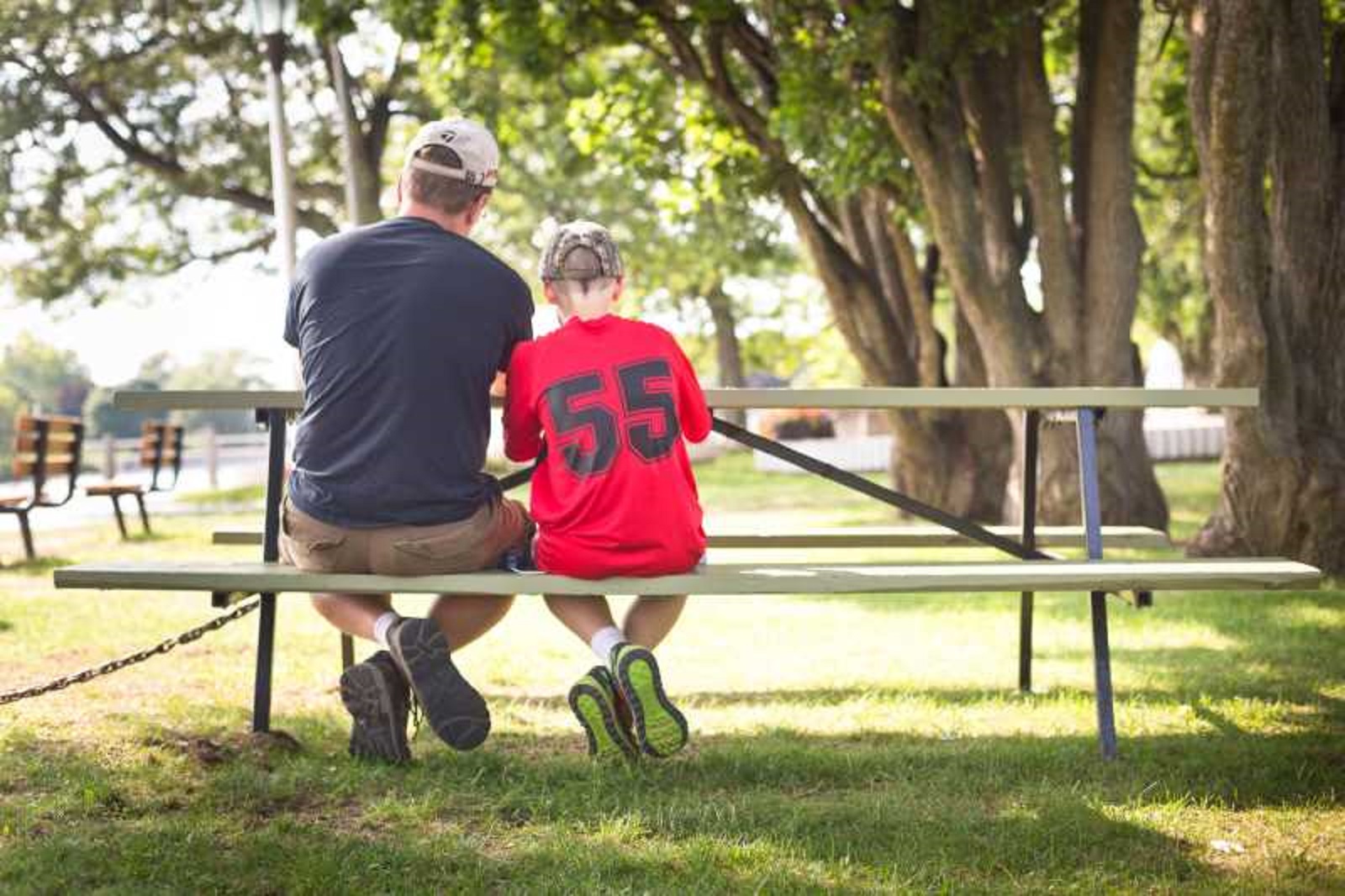 Parent and child sitting at picnic table