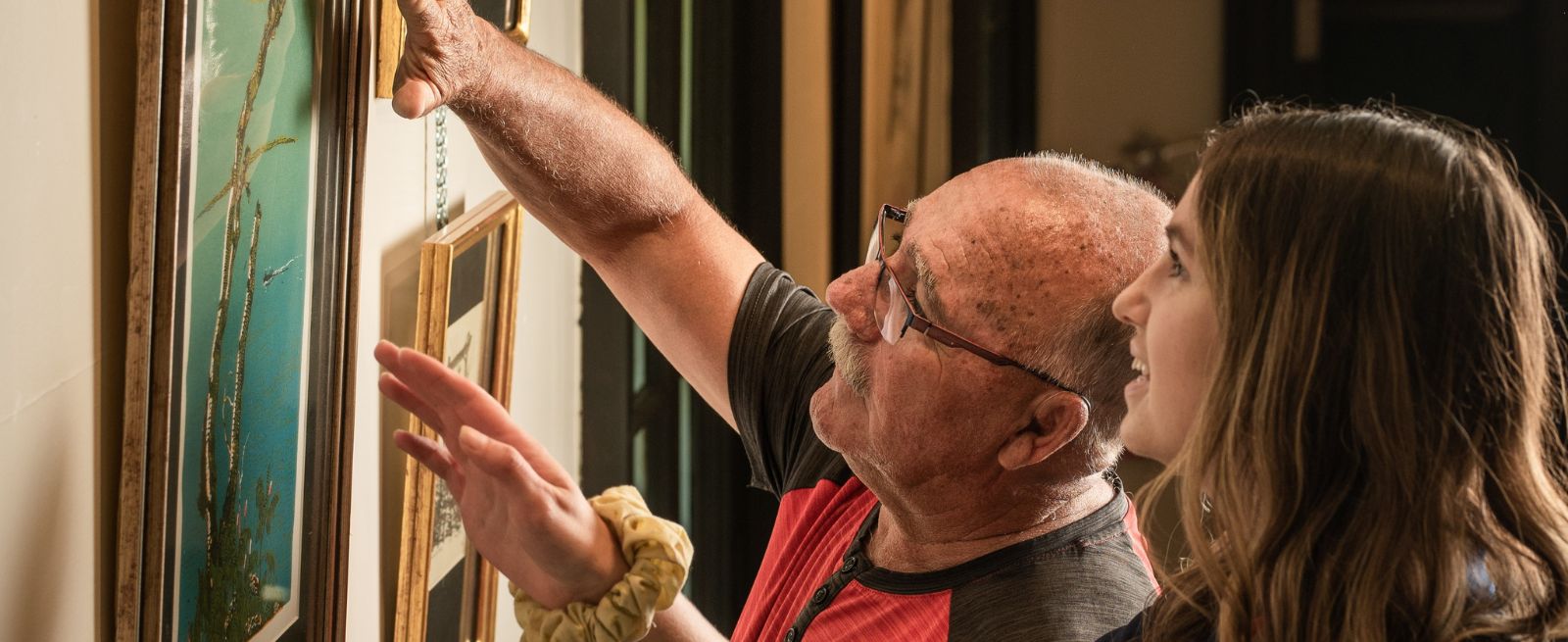 2 people looking at artwork on a wall