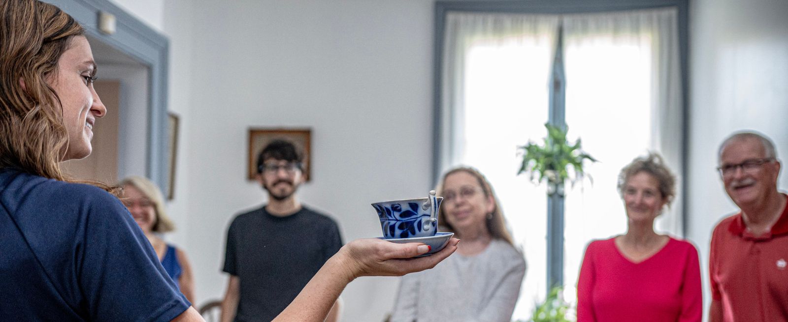 people looking at museum artifacts